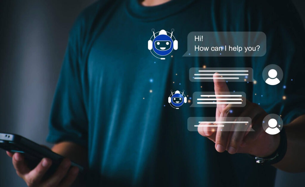 Person in a dark shirt interacting with a chatbot interface on a mobile device, displaying text messages and a friendly chatbot graphic.