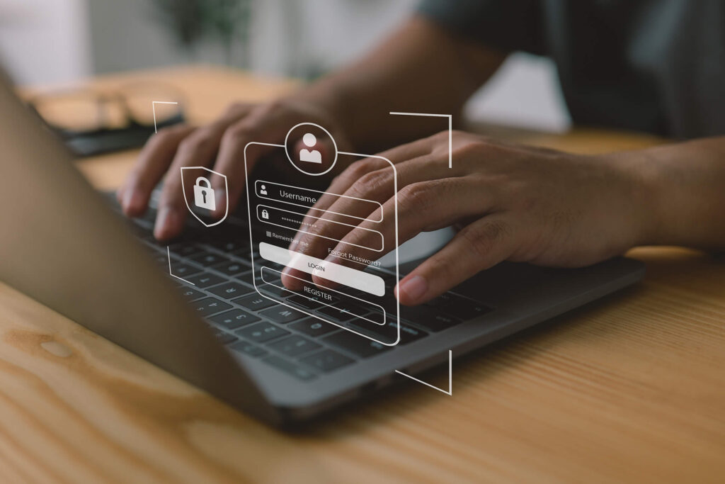 Hands typing on a laptop keyboard with an overlay of a login interface showing fields for username and password.