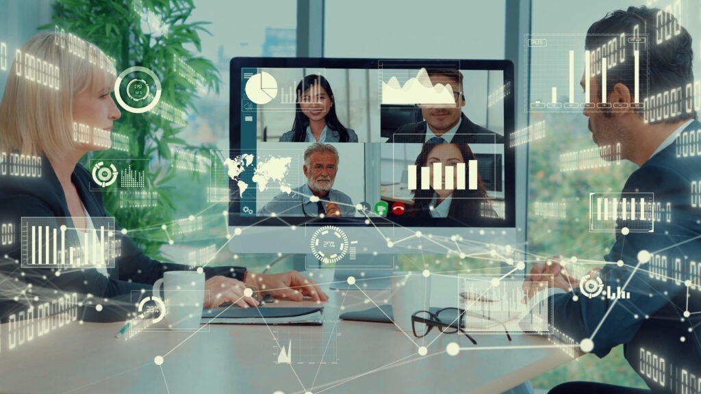 Two professionals engaged in a video conference on a computer, with data visualizations and graphs overlayed.